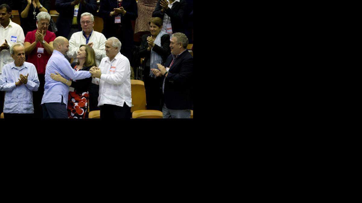 
In this Dec. 20, 2014 photo, Cuba’s head of North American affairs, Josefina Vidal, front row center, embraces Gerardo Hernandez, member of “The Cuban Five,” at the closing of the twice-annual legislative session at the National Assembly in Havana. 
