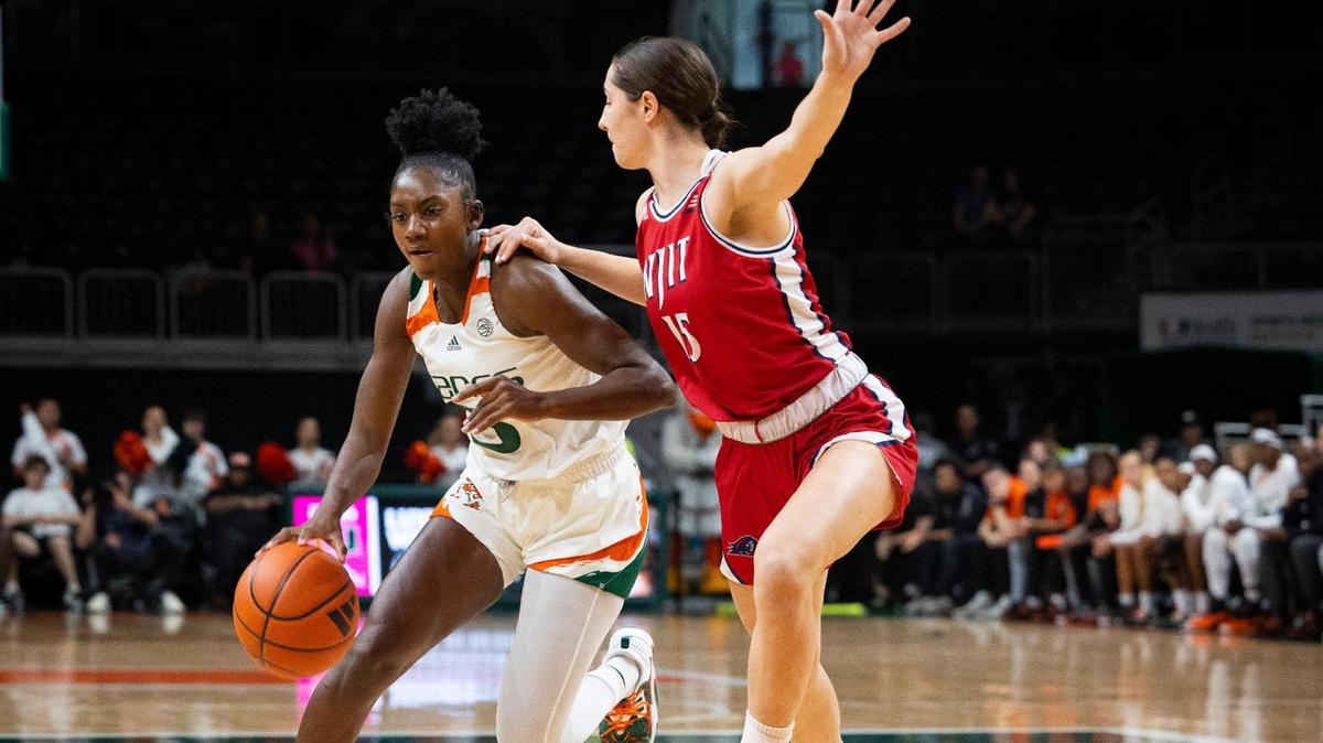 Miami Hurricanes Jaida Patrick (5) dribbles around NJIT’s Madilyn Dogs (15) during the first quarter of a game on Sunday, Dec. 3, 2023, at the Watsco Center in Coral Gables.