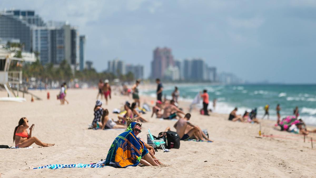Beachgoers sunbathe at Las Olas Beach in Fort Lauderdale, Florida on Saturday, May 30, 2020.
