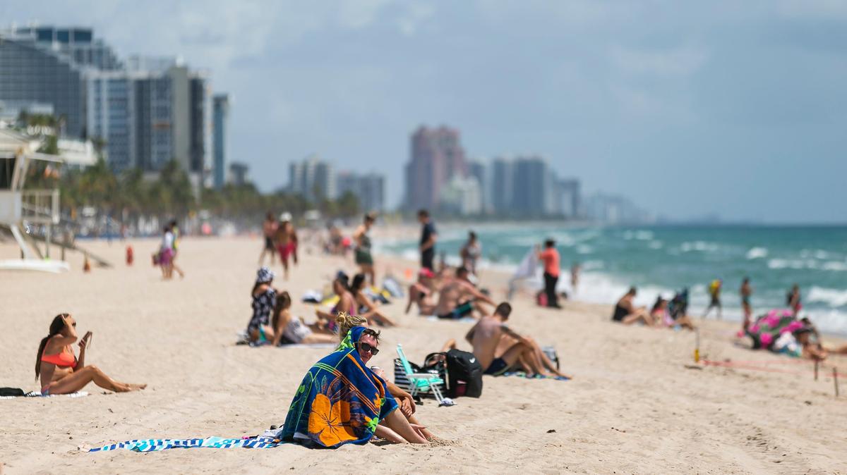 Beachgoers sunbathe at Las Olas Beach in Fort Lauderdale, Florida on Saturday, May 30, 2020.