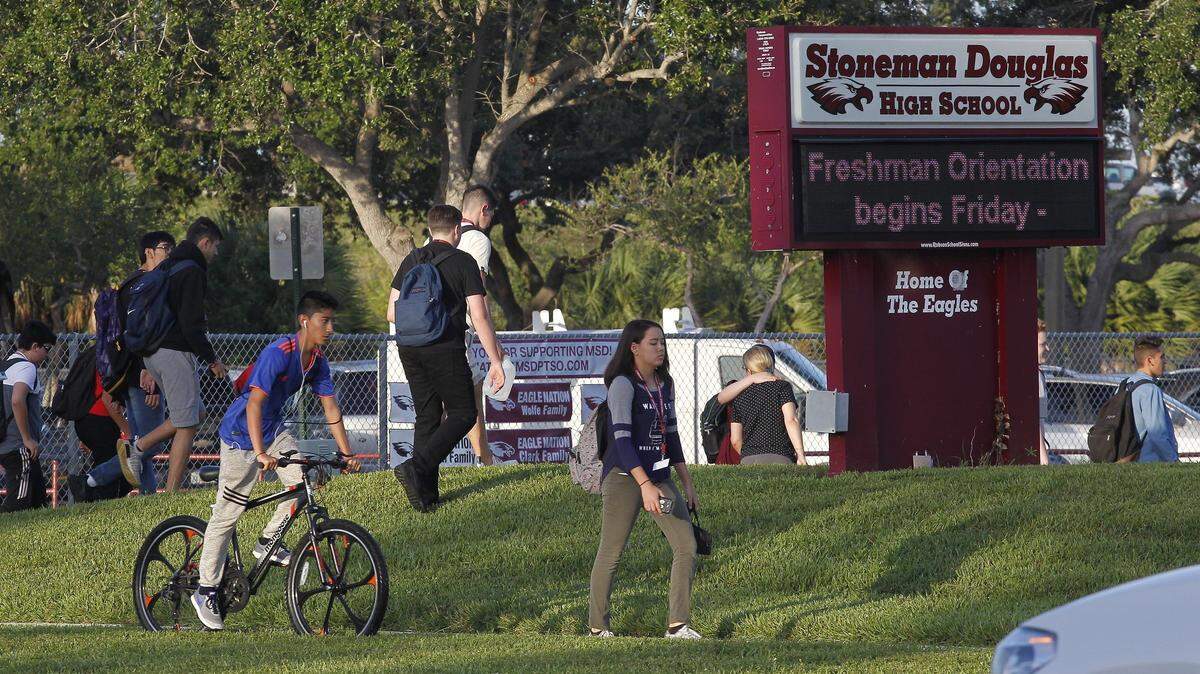 Students make their way to the start of school at Marjory Stoneman Douglas High School in Parkland on Wednesday, Aug. 15, 2018.