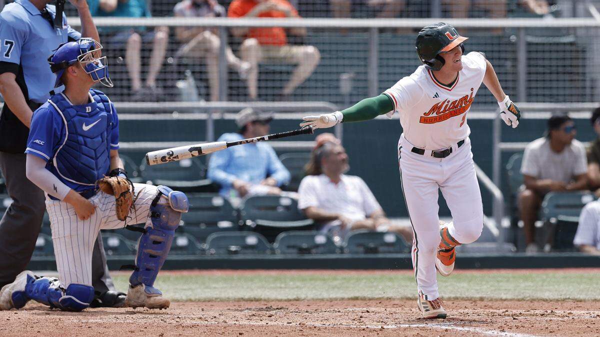 Miami Hurricanes outfielder Zach Levenson (9) hits a grand slam, bringing in Edgardo Villegas (45), CJ Kayfus (2) and Blake Cyr (4) in the third inning against Dukes at Mark Light Field at Alex Rodriguez Park in Coral Gables, Florida in the regular-season finale on Saturday, May 20, 2023.