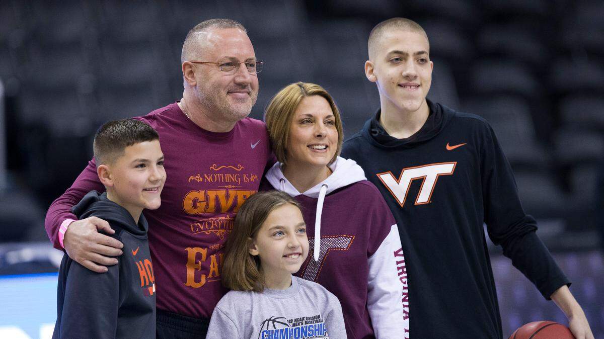 Virginia Tech’s head coach Buzz Williams poses with his family during an NCAA men’s college basketball practice in Washington, Thursday, March 28, 2019. Virginia Tech plays Duke in an East Regional semifinal game on Friday.