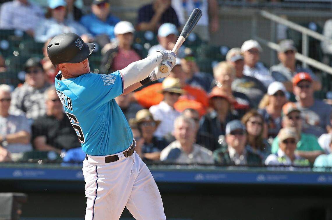 Miami Marlins left fielder Garrett Cooper (26) hits a single during the fourth inning of a Major League Baseball spring training game against the Houston Astros at the Roger Dean Chevrolet Stadium on Thursday, March 7, 2019 in Jupiter, FL.