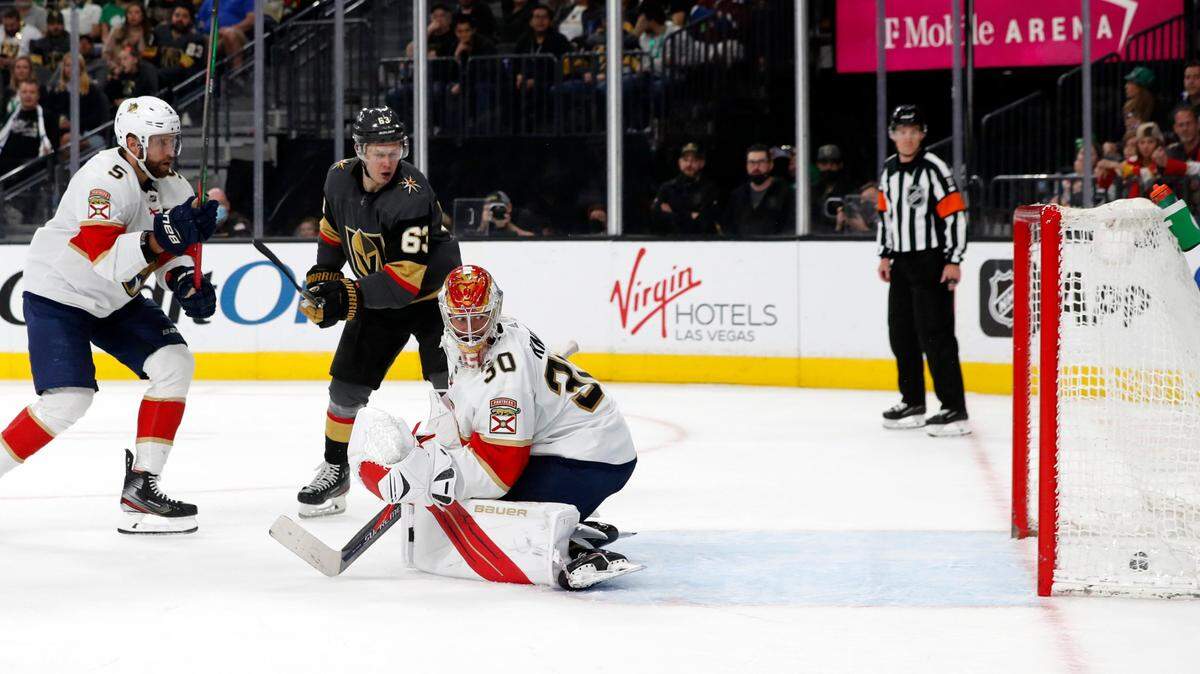 Vegas Golden Knights right wing Evgenii Dadonov (63) scores past Florida Panthers goaltender Spencer Knight (30) during the second period of an NHL hockey game Thursday, March 17, 2022, in Las Vegas. Panthers defenseman Aaron Ekblad is at left. (AP Photo/Steve Marcus)