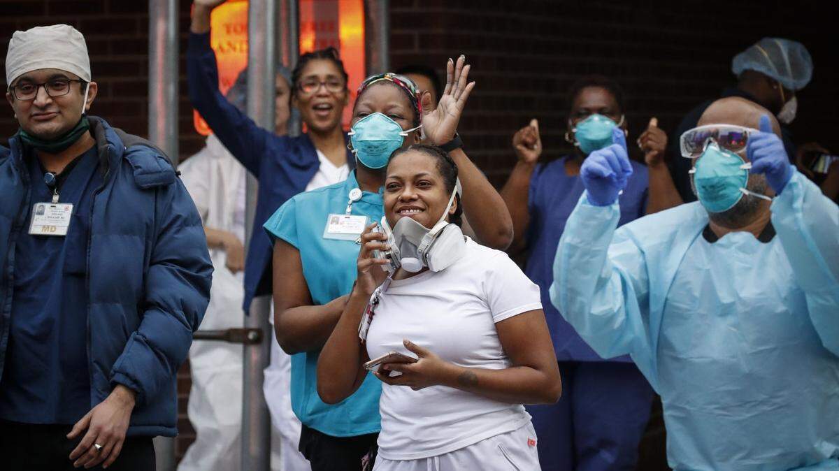 In New York, medical workers acknowledged pedestrians and firefighters who gathered to applaud them as they left work at Brooklyn Hospital Center.