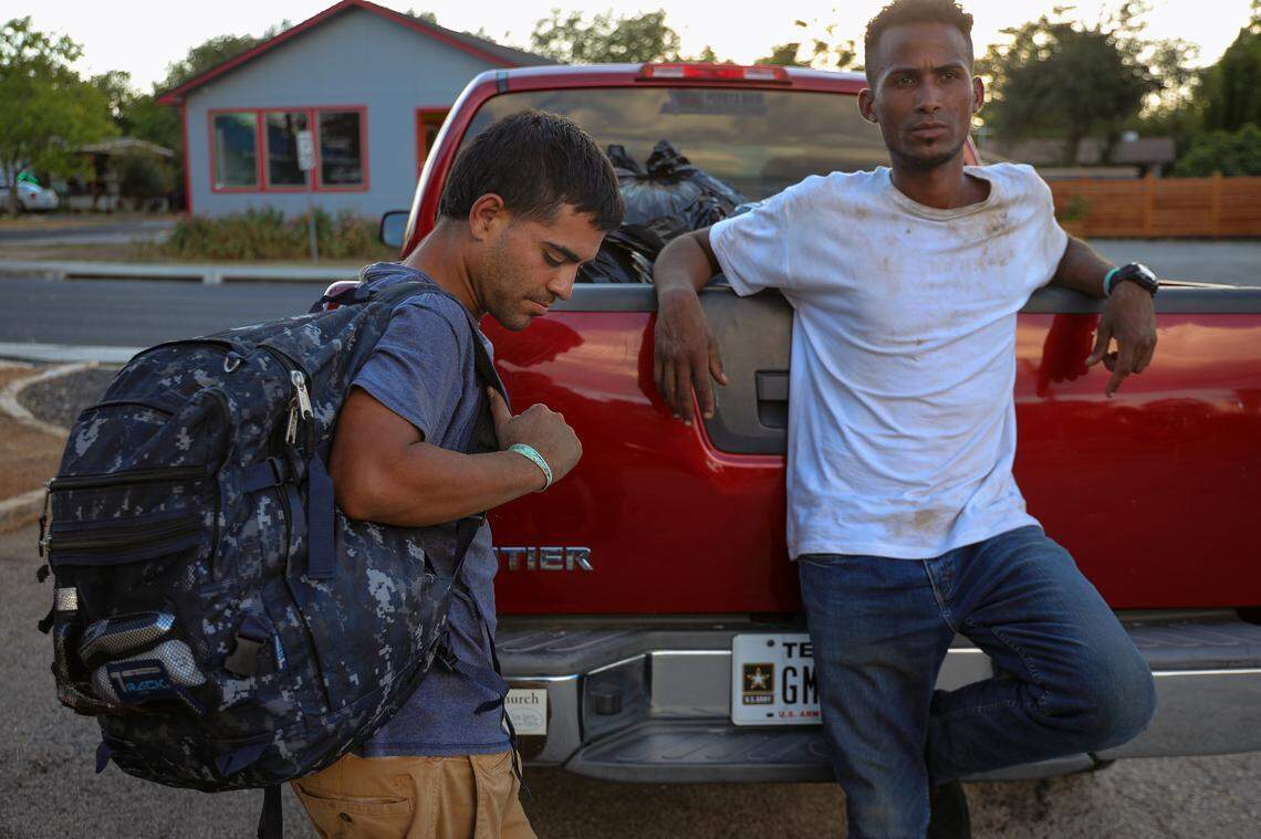Venezuelan migrant Irwign Gutiérrez, 28, right, and friend Joryi Perez, 28, left, completed a day’s work. The two gather their personal items while waiting to be transported back to the Migrant Resource Center.