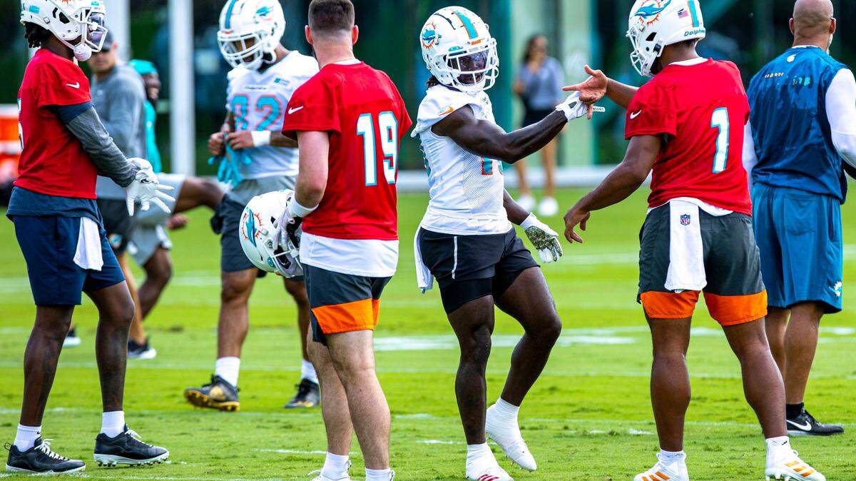 Miami Dolphins quarterback Tua Tagovailoa (1) daps up new wide receiver Tyreek Hill (10) during the first day of mandatory mini-camp at Baptist Health Training Complex in Miami Gardens, Florida, on Wednesday, June 1, 2022.