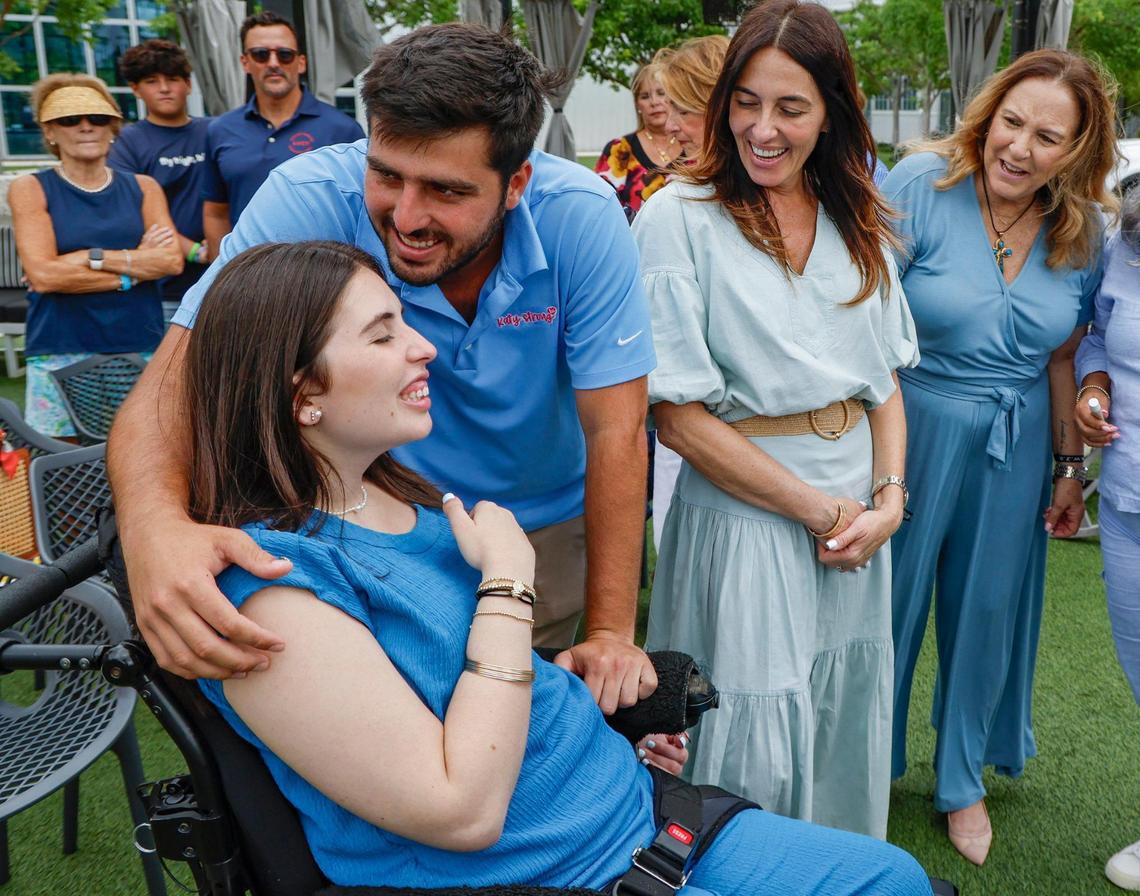 Boating accident survivor Katerina “Katy” Puig, is hugged by her brother Rudy Puig Jr. at a press conference commemorating the enactment of Lucy’s Law at Bayshore Club in Miami, Florida, on Wednesday, July 2, 2025. The new state law toughens penalties for boaters in boat crashes with serious injuries. The law honors 17-year-old Luciana Fernandez, the Miami teen who died after a 2022 boat crash in Biscayne Bay.