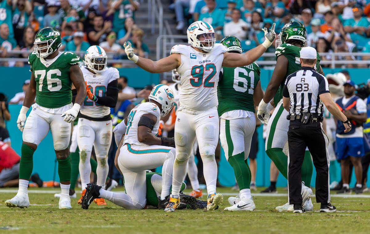Miami Dolphins defensive tackle Zach Sieler (92) reacts after sacking New York Jets quarterback Aaron Rodgers (8) during the second half of their NFL game at Hard Rock Stadium on Sunday, Dec. 8, 2024, in Miami Gardens, Florida.