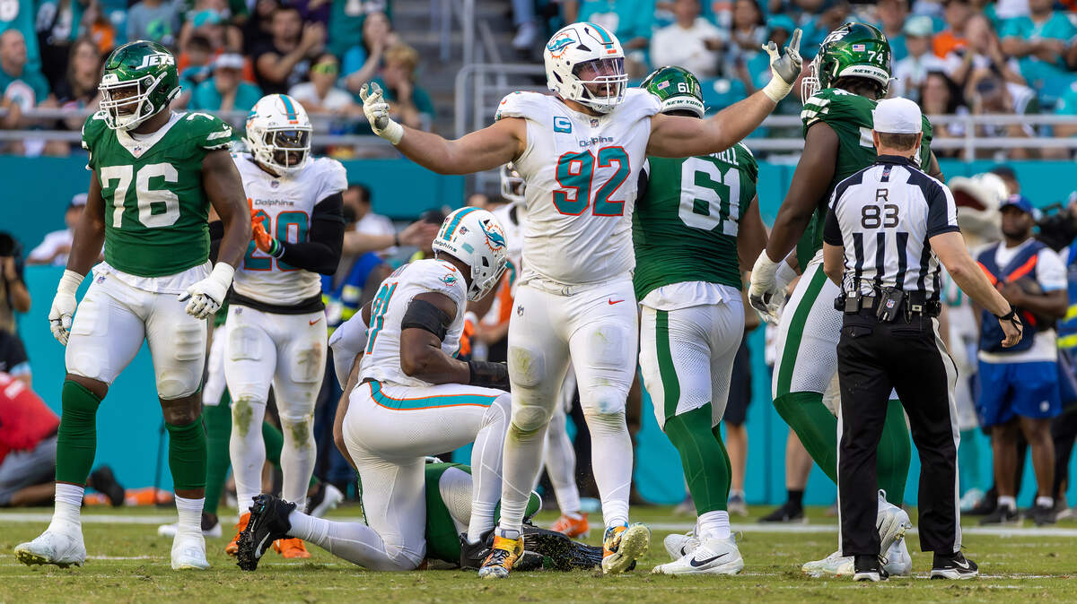 Miami Dolphins defensive tackle Zach Sieler (92) reacts after sacking New York Jets quarterback Aaron Rodgers (8) during the second half of their NFL game at Hard Rock Stadium on Sunday, Dec. 8, 2024, in Miami Gardens, Florida.