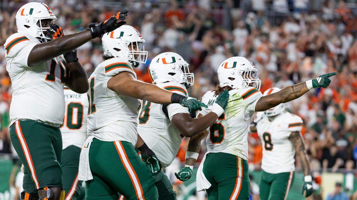Miami Hurricanes running back Damien Martinez (6) celebrates with his teammates after scoring two extra points against the South Florida Bulls in the first half of his NCAA college football game at the Raymond James Stadium on Saturday, Sept. 21, 2024, in Tampa, Fla.