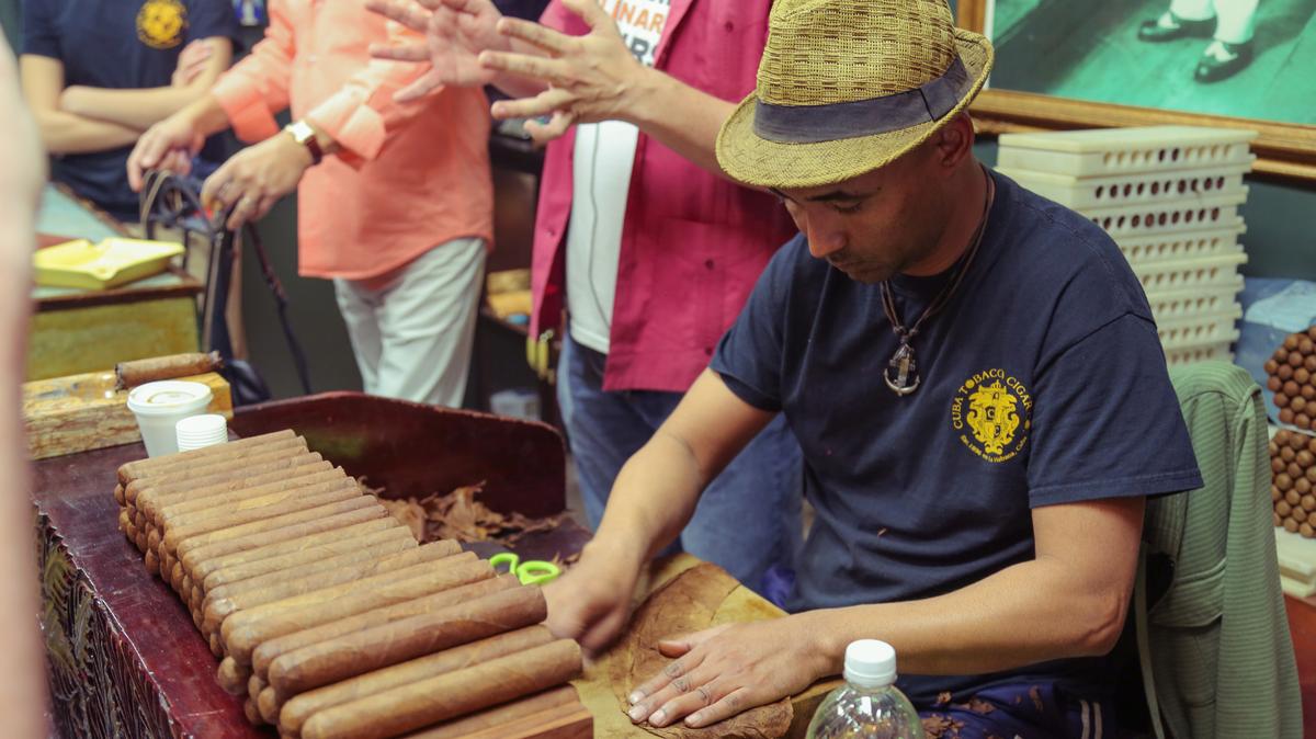 A cigar roller at Havana Classic Cigar shows guests on a Miami Culinary Tour of Little Havana how he works. Cuban-American history is a huge part of the tour, which also includes Cuban cuisine (and a mojito).
