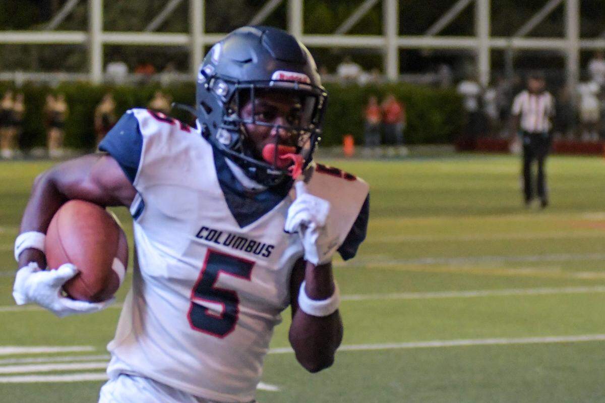 Miami Columbus safety Ahmere Foster returns an interception for a touchdown in a game against Doral Academy on Friday, Oct. 14, 2022, at Doral Academy.