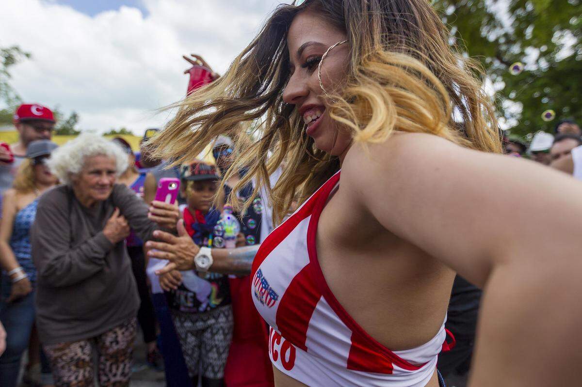 Kassie rivera, 20, dances in the middle of a crowd during the Carnival Miami Calle Ocho festival in Little Havana on Sunday, March 11, 2018.