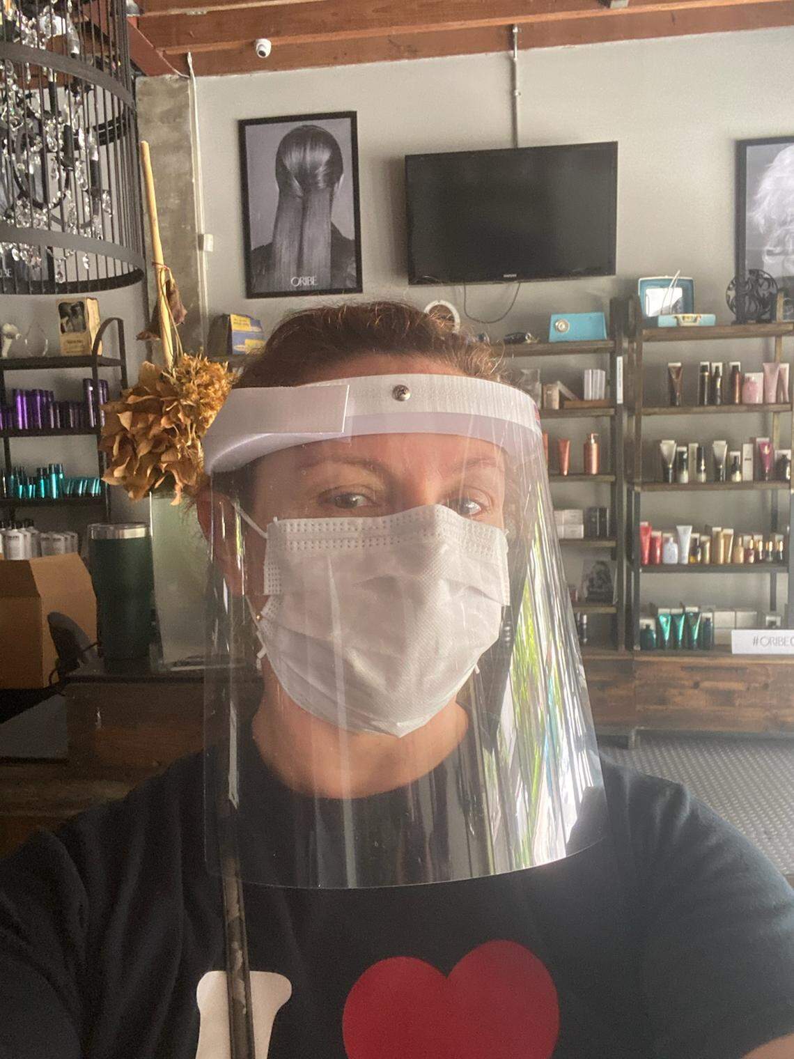 Christine Martinez, owner of Avant Garde Salon and Spa in Coral Gables, shows off the “new uniform.”