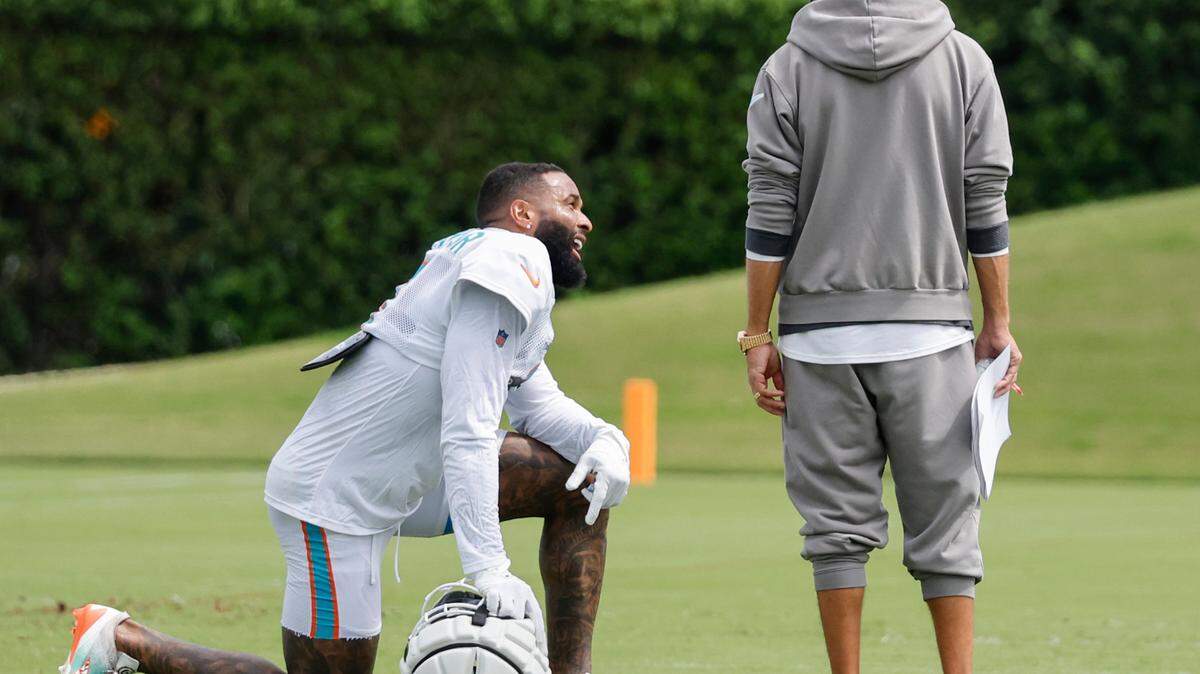 Miami Dolphins wide receiver Odell Beckham Jr. (3) speaks with coach Mike McDaniel on the field at the Miami Dolphins training facility in Miami Gardens, Fla., on Thursday, October 3, 2024.
