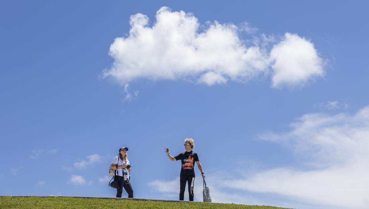 People visit South Pointe Park as hot weather moves through the area on Friday, Aug. 15, 2025, in Miami Beach, Fla. Forecasters have issued heat advisories throughout the summer in South Florida, with temperatures at times feeling as hot as 109 degrees.
