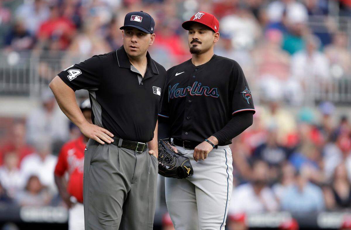 Miami Marlins pitcher Pablo Lopez, right, speaks with an umpire after hitting Atlanta Braves’ Ronald Acuna Jr. with his first pitch in the first inning of a baseball game Friday, July 2, 2021, in Atlanta. (AP Photo/Ben Margot)
