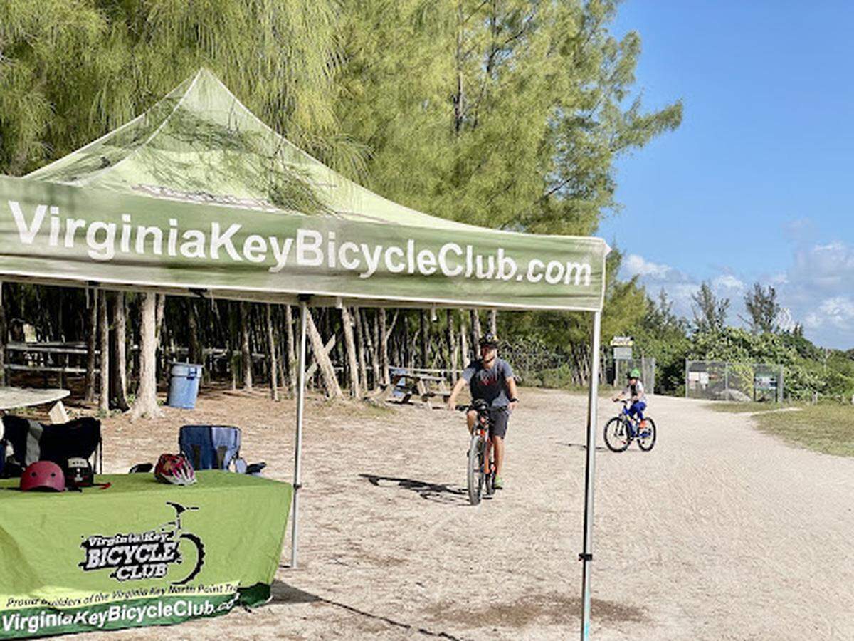 A father and son enjoy a sunny day biking through the Virginia Key North Point Trail.