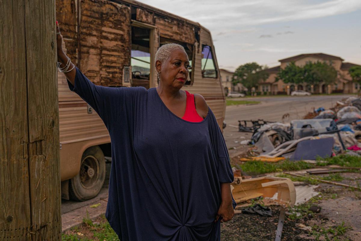 Resident Sonya Brown-Wilson poses for a portrait as she looks at the trash in the empty lot on Northwest 74th Street and Northwest 25th Avenue in Miami on Nov. 30, 2022.