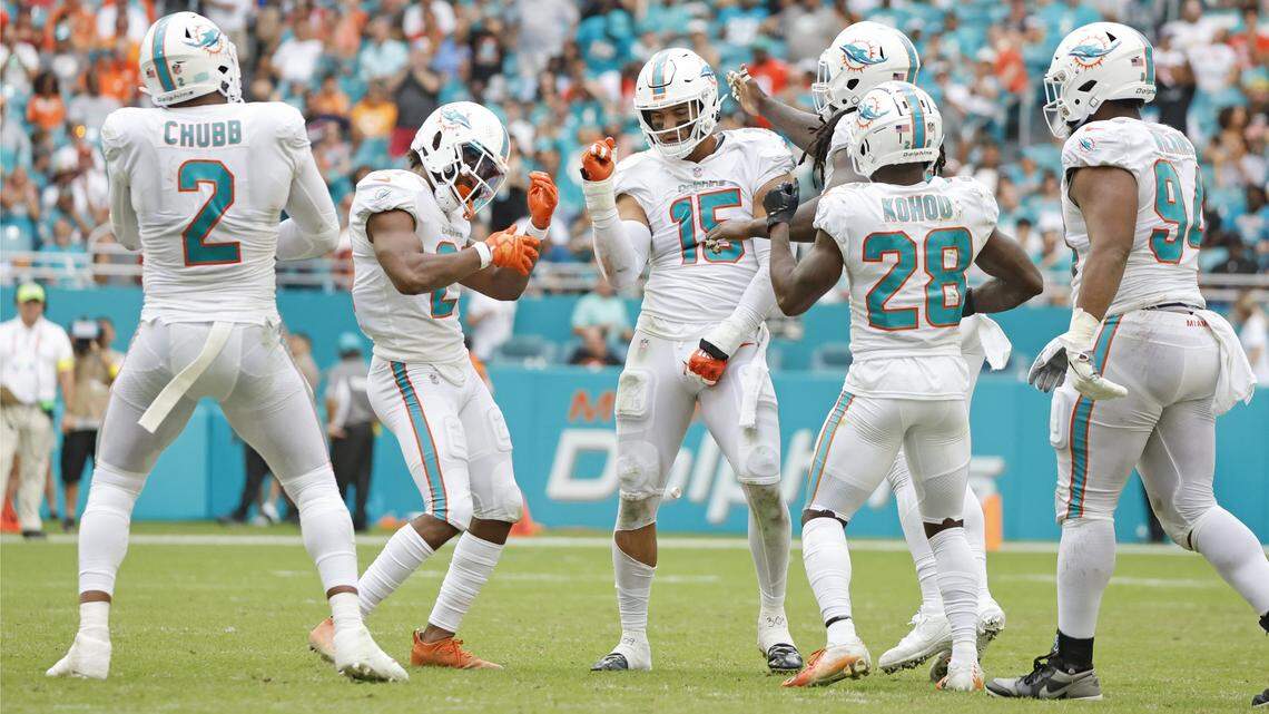 Miami Dolphins linebacker Jaelan Phillips (15) celebrates with teammates after Phillips sacks Houston Texans quarterback Kyle Allen (3) in the second half at Hard Rock Stadium in Miami Gardens on Sunday, November 27, 2022.