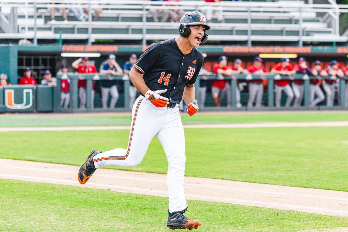 Miami Hurricanes third baseman Daniel Cuvet of Miami hits a 2-run homer against FAU in the first inning on Tuesday, April 9, 2024 at Mark Light Field.