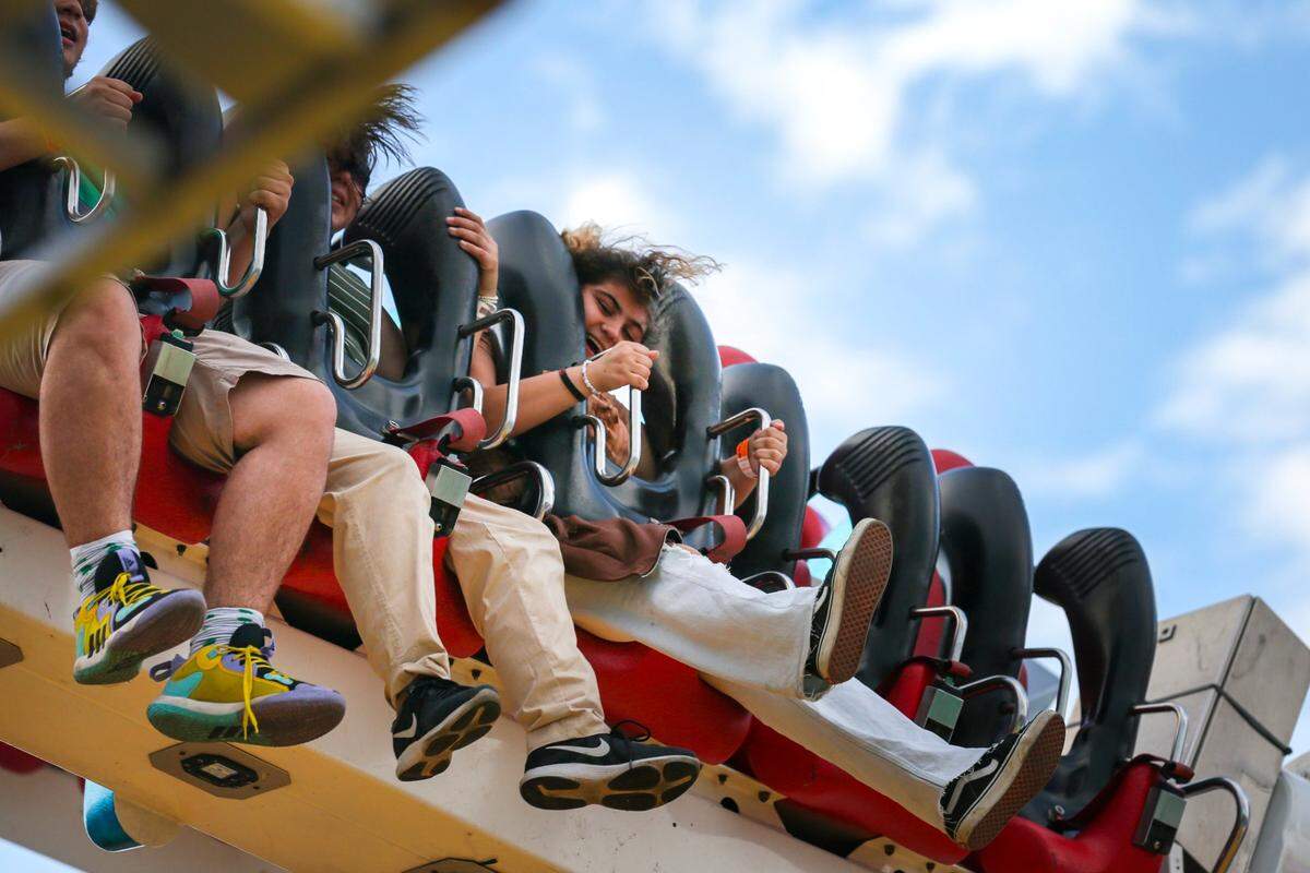 Fairgoers enjoy one of the rides during the opening day of the Miami-Dade County Youth Fair at the Miami-Dade Fair & Expo Center in Miami, Florida, on Thursday, March 17, 2022.
