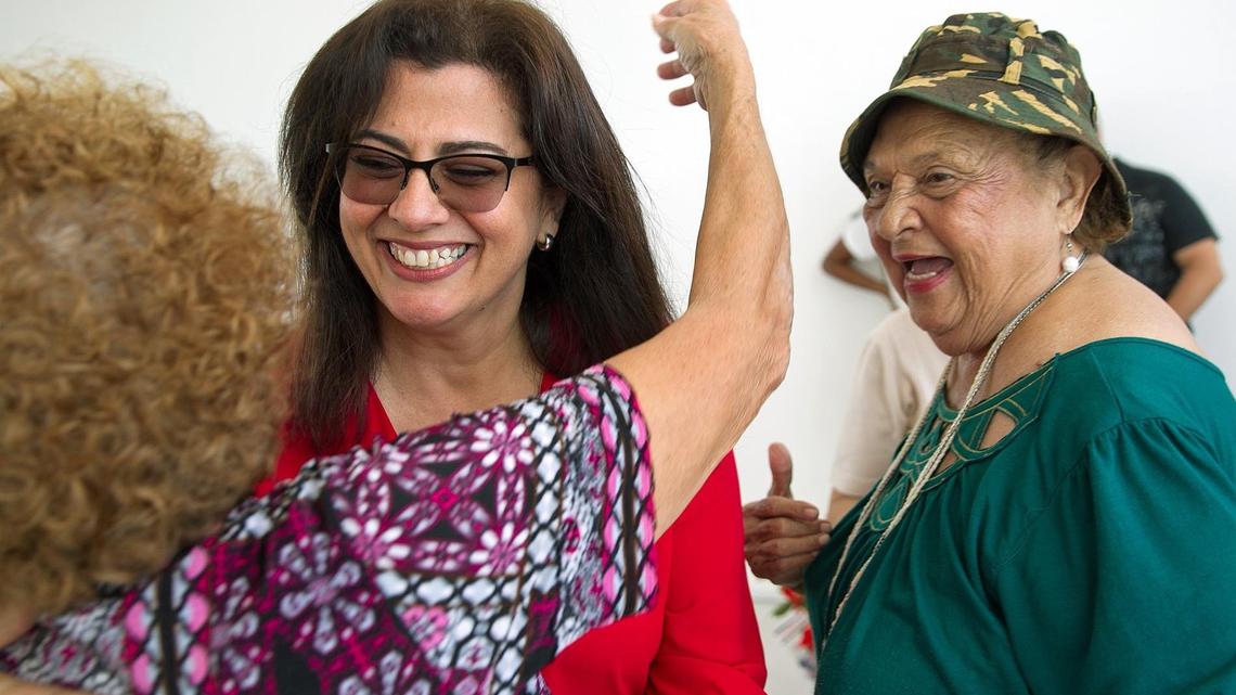 Miami-Dade Commission candidate Zoraida Barreiro shares a laugh with supporters at Unidad Miami Beach on Collins Avenue on Wednesday, May 9, 2018.