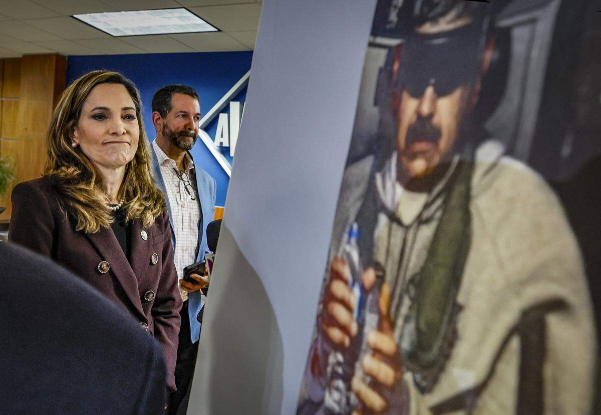 United States Repsresentative Maria Elvira Salazar looks at a photograph of a captured Venezuelan leader Nicolás Maduro on display during a pres. conference in Doral, Florida on Saturday, January 3, 2026. 