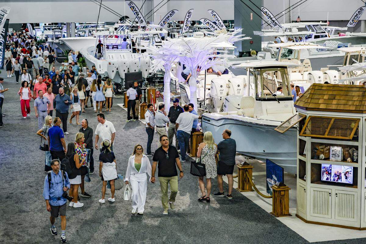 Attendees tour boats on display at the Miami Beach International Boat Show in the Miami Beach Convention Center on Miami Beach, Florida on Thursday, February 12, 2026.
