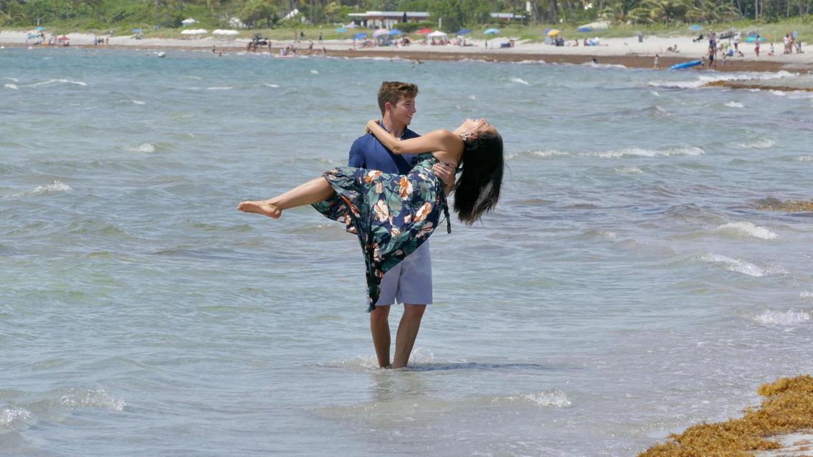 Leanna and John Fishburnes spin around in the water on Crandon Park’s south beach as they are photographed for engagement photos on the first Saturday of beaches being reopened in Miami-Dade.