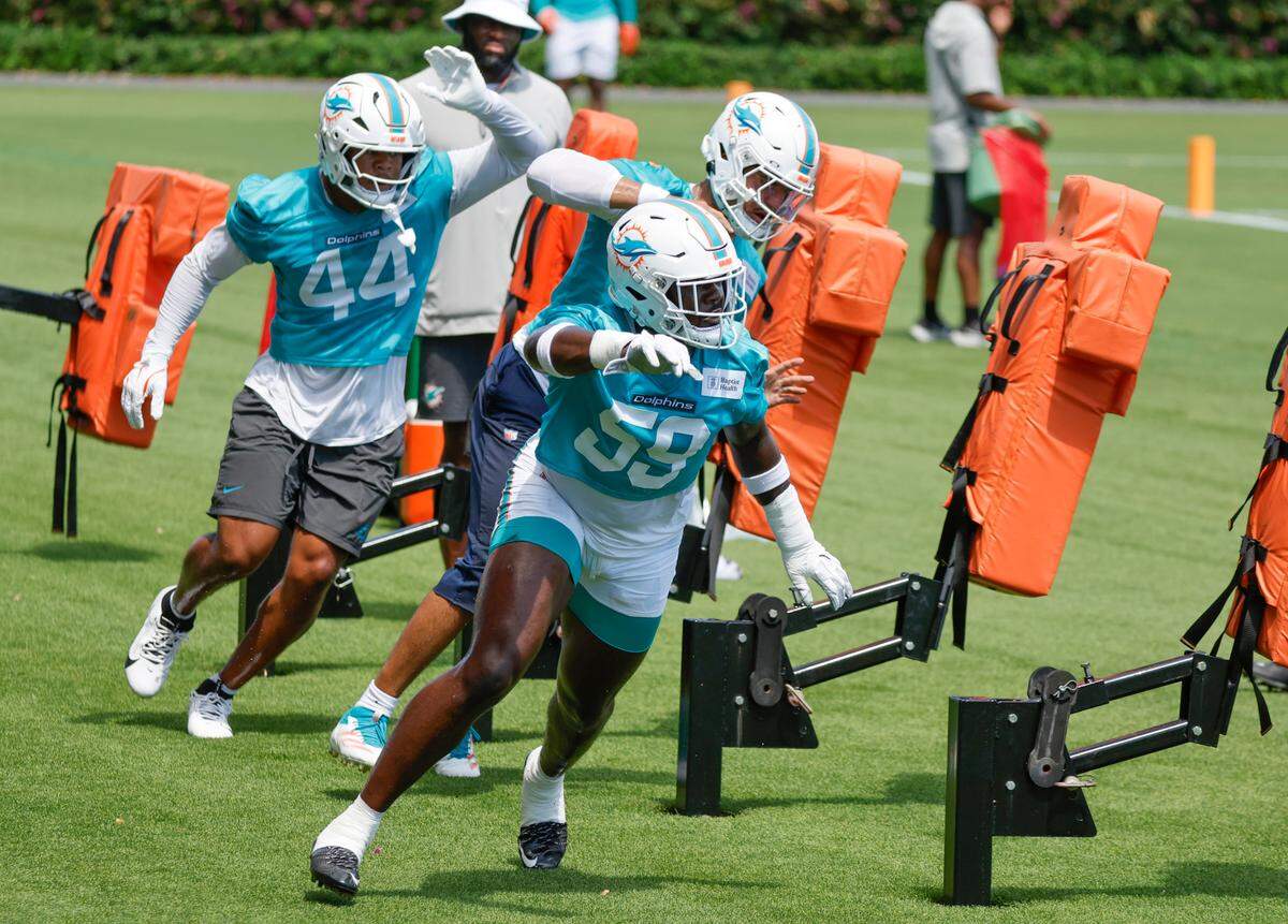 Miami Dolphins linebackers Derrick McLendon (59) Chop Robinson (44) and Jaelan Phillips (15) participate in practice drills during mandatory minicamp at the Baptist Health Training Complex in Miami Miami Gardens, Florida on Tuesday, June 10, 2025 