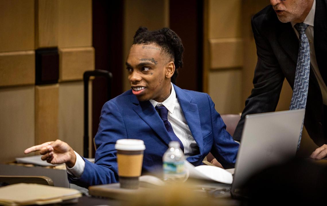 Jamell Maurice Demons, known professionally as YNW Melly, talks to a member of his defense team just before opening statements at his double murder trial on Monday, June 9, 2023, in a Fort Lauderdale court.