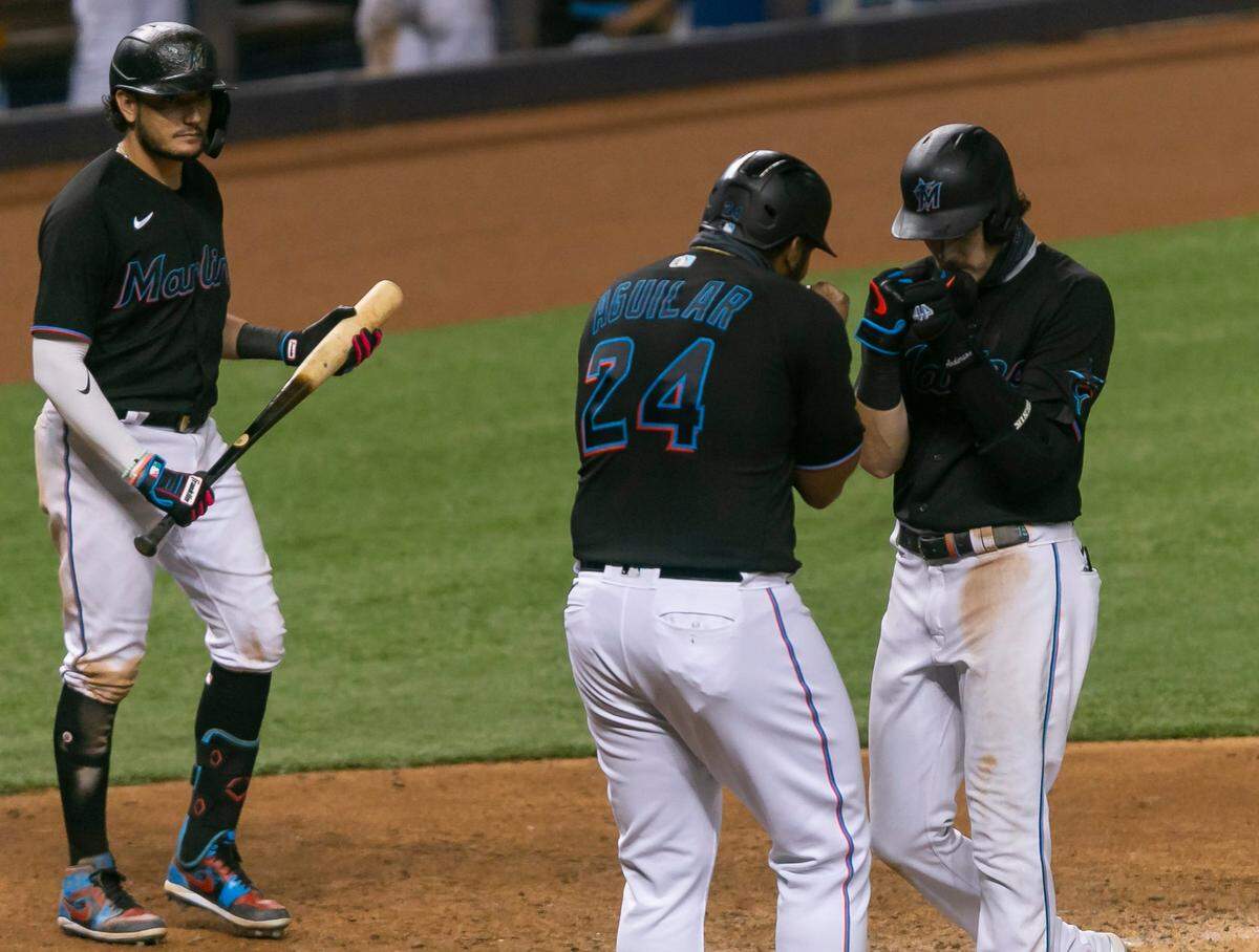 Miami Marlins third baseman Brian Anderson (15) celebrates with Miami Marlins first baseman Jesus Aguilar (24) after hitting a home run in the sixth inning of a Major League Baseball game during the second game of a doubleheader against the Washington Nationals at Marlins Park in Miami, Florida on Friday, September 18, 2020.