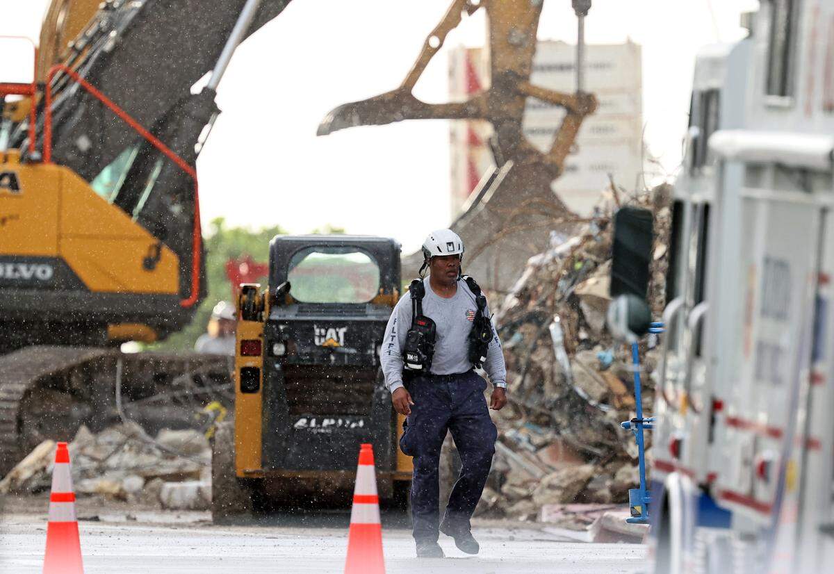 Search and rescue personnel search for survivors through the rubble at the Champlain Towers South Condo in Surfside, Florida, Sunday, June 27, 2021. The apartment building partially collapsed on Thursday, June 24.