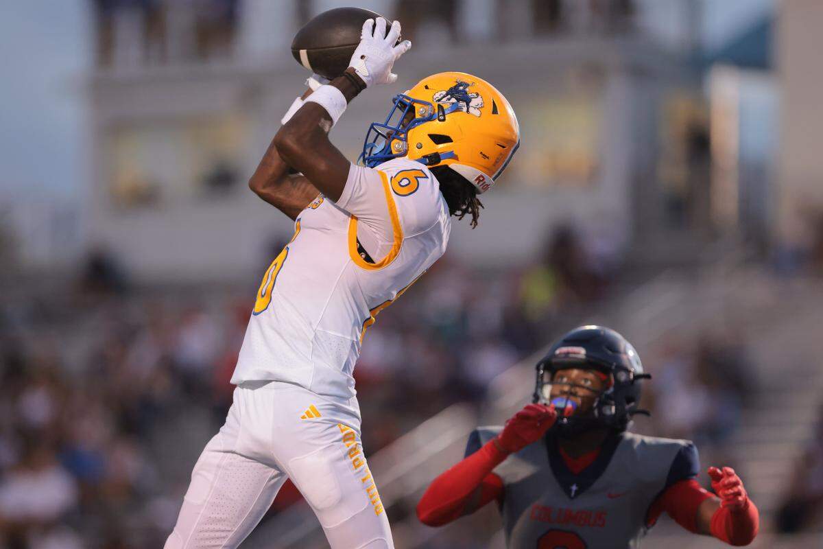 Northwestern Bulls wide receiver Kenyan Thompkins (6) catches the football for a touchdown against the Columbus Explorers during the first quarter of a high school football game at Tropical Park in Miami, Florida, Friday, September 19, 2025.