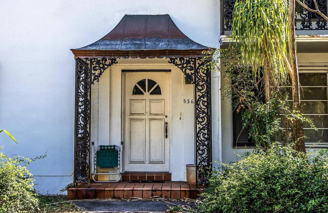 Wrought iron and a copper canopy decorate the entryway of one if 13 affordable, older small apartment buildings and duplexes on a Coral Gables city block that will be torn down to make way for a luxury residential development. The block is bounded by Malaga Avenue and Santander Avenue to the north and south, and Segovia Street and Hernando Street on the west and east.