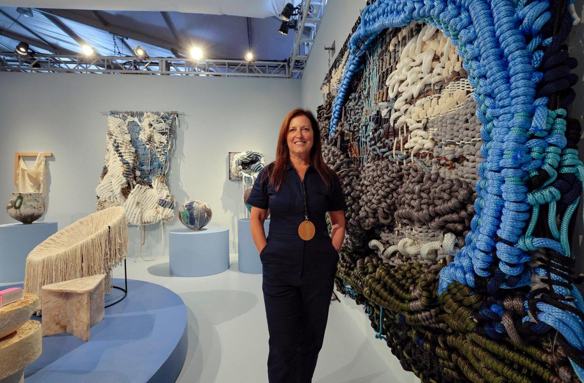 Mindy Solomon stands next to a monumental tapestry by Jaqueline Surdell at the Mindy Solomon Gallery at Design Miami on Miami Beach, Florida on Tuesday, December 3, 2024.