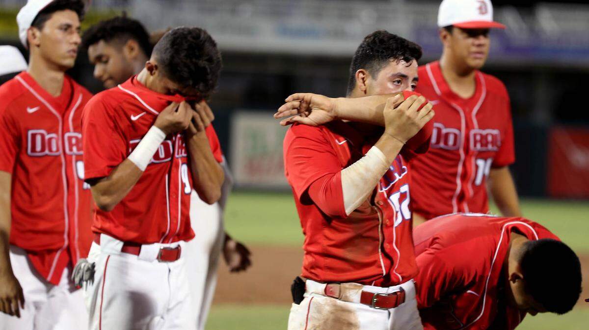 Doral Academy Anthony Bordone (52) and Andres Vidal (9) get emotional after being defeated by Venice HS in the FHSSA Finals Class 7A Division at CenturyLink Sports Complex - Hammond Stadium in Fort Myers, Florida, Saturday, June, 1, 2019.