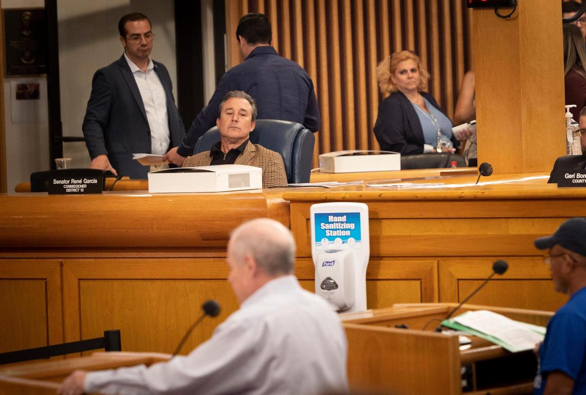 Commissioner René Garcia, center, listens to public comment during a Miami-Dade county commission Community Health Committee meeting prior to the vote on the Miami Dade heat standard for outdoor workers on Monday, Sept. 11, 2023. Garcia was the only commissioner to vote against the bill.