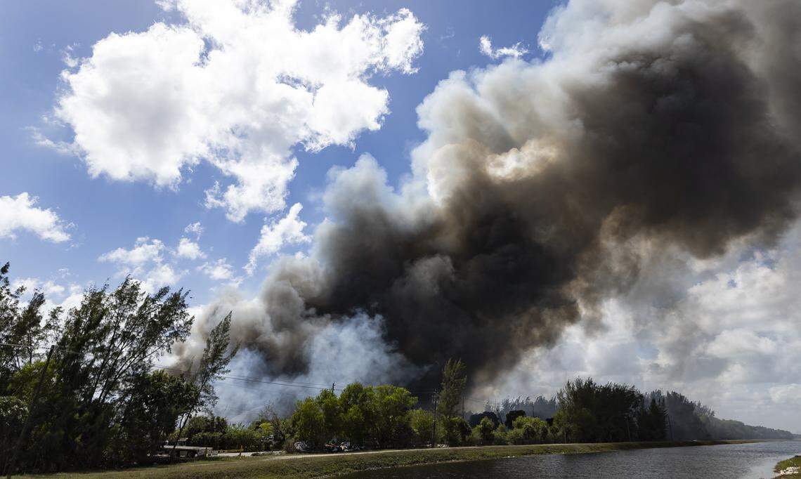 Firefighters work to contain a fire at a six-story warehouse on Thursday, March 5, 2026, in Miami Gardens, Fla.