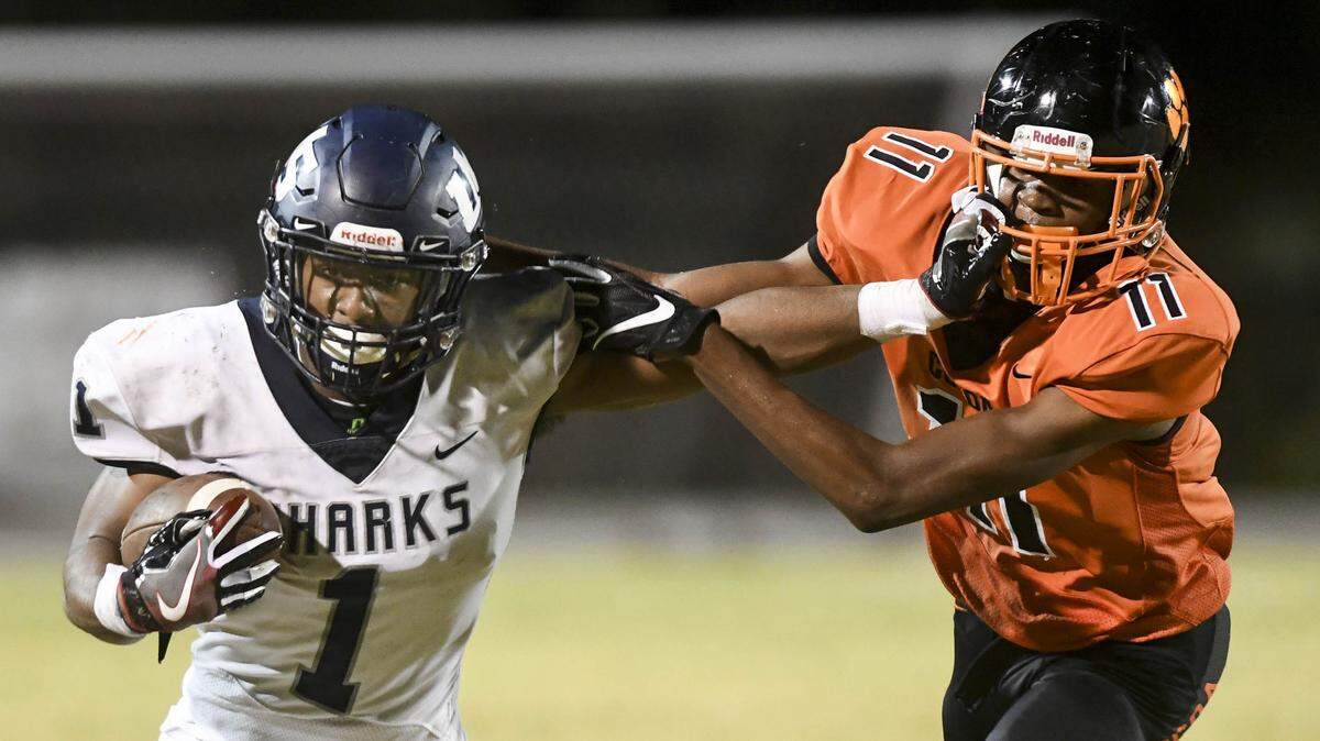 University’s Kenny Mcintosh stiff arms Cocoa defender Jamari Williams during Friday’s Class 4A state semifinal.
