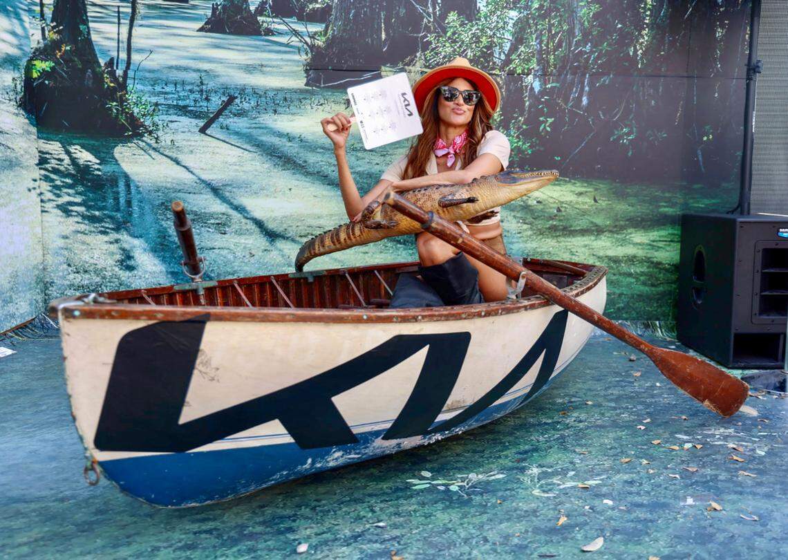 Model Everlayn Borges, 21, sits in a swamp installation waiting to be photographed by Calle Ocho Music Festival attendees on Sunday, March 12, 2023.