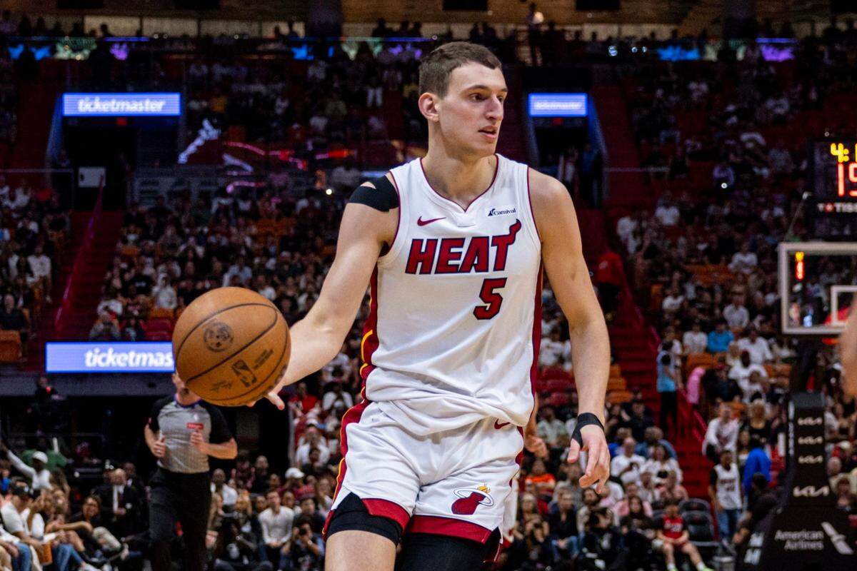 Miami Heat forward Nikola Jovic (5) dribbles the ball during the second half of an NBA game at Kaseya Center in Miami on April 12, 2024.