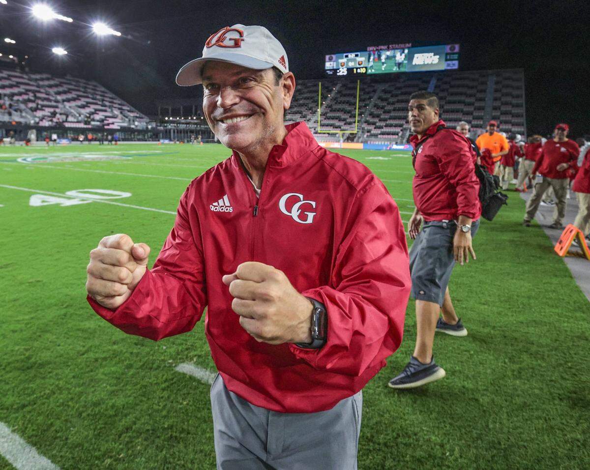 Cardinal Gibbons head coach Matthew Dubuc pumps his fists in the final seconds of the game as the Chiefs defeat the Cocoa Tigers at DRV PNK Stadium, in Fort Lauderdale on Thursday, December 16, 2021.