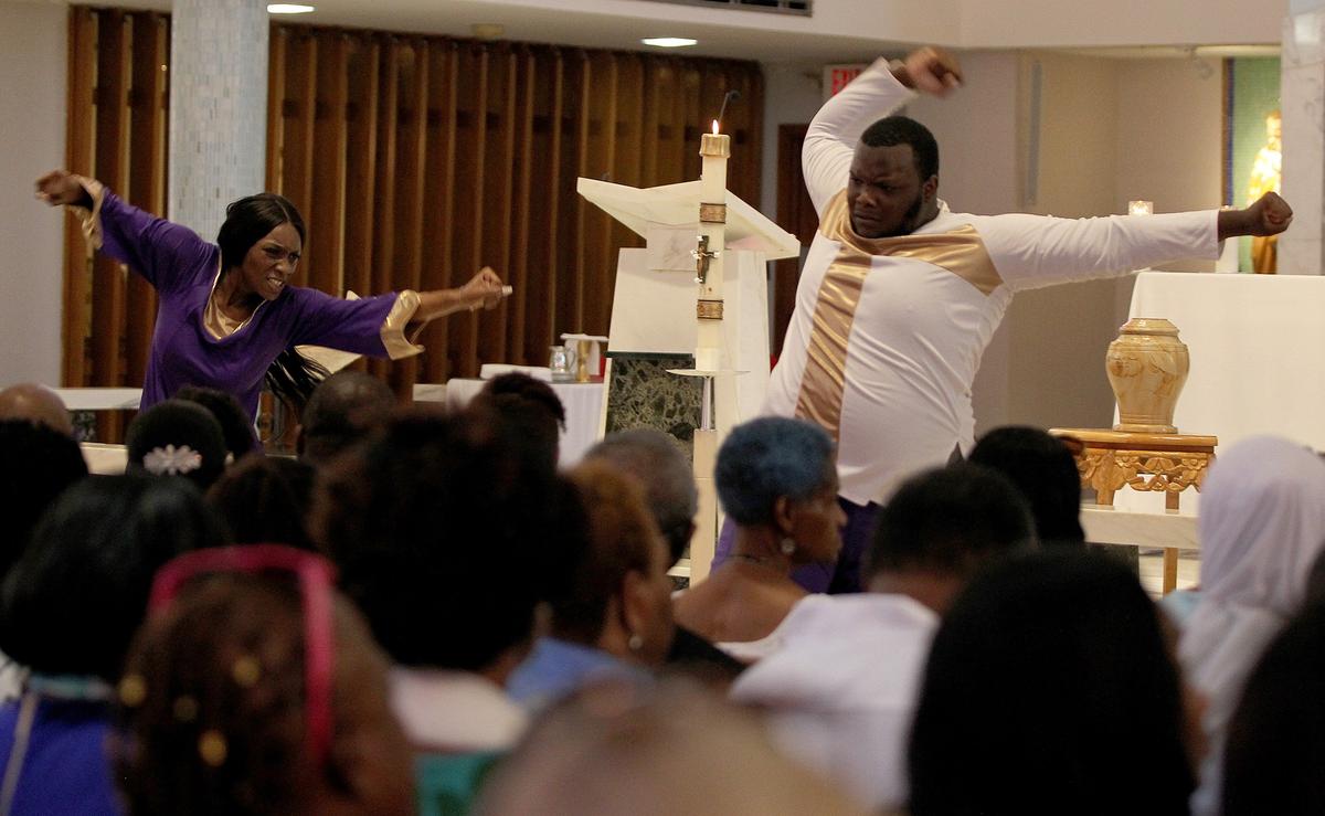Dancers Glenthea James and Evric Hudnell performed during the funeral services for Kameela Russell, at St. James Catholic Church, in North Miami. Miss. Russell, a teacher at Miami Norland Senior High was reported missing on May 15 and was found dead 10 days later in a canal in Miami Gardens. on Saturday June 22, 2019.