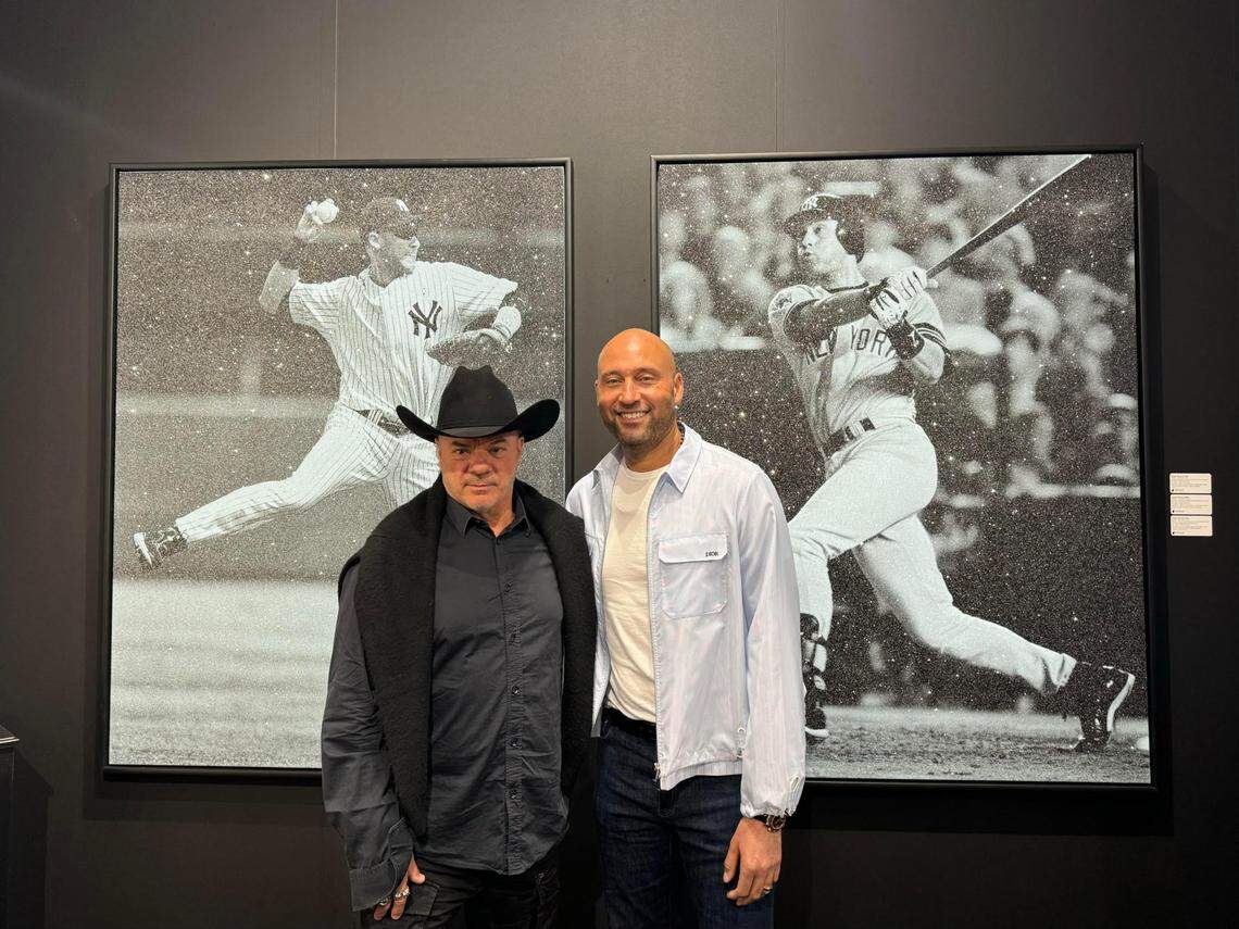 Former MLB star Derek Jeter (right) poses with artist Russell Young, who created two works of art around Jeter’s famous plays.