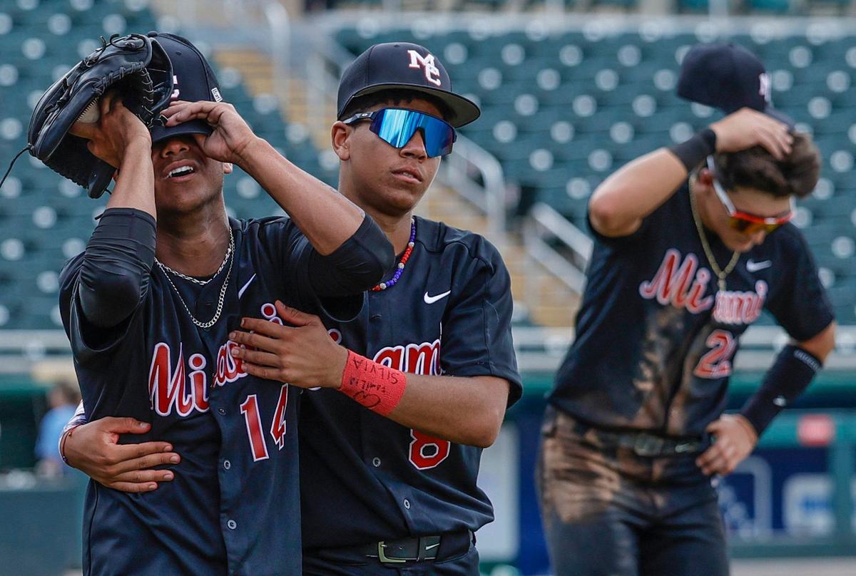 Miami Christian Victors pitcher Hector Escobar (14) is consoled by Kevin Bruno (8) after the Victors lose to the St. Johns Spartans in extra innings during the FHSAA Baseball Class 2A State Final at Hammond Stadium in Fort Myers, Florida on Wednesday, May 22, 2024.