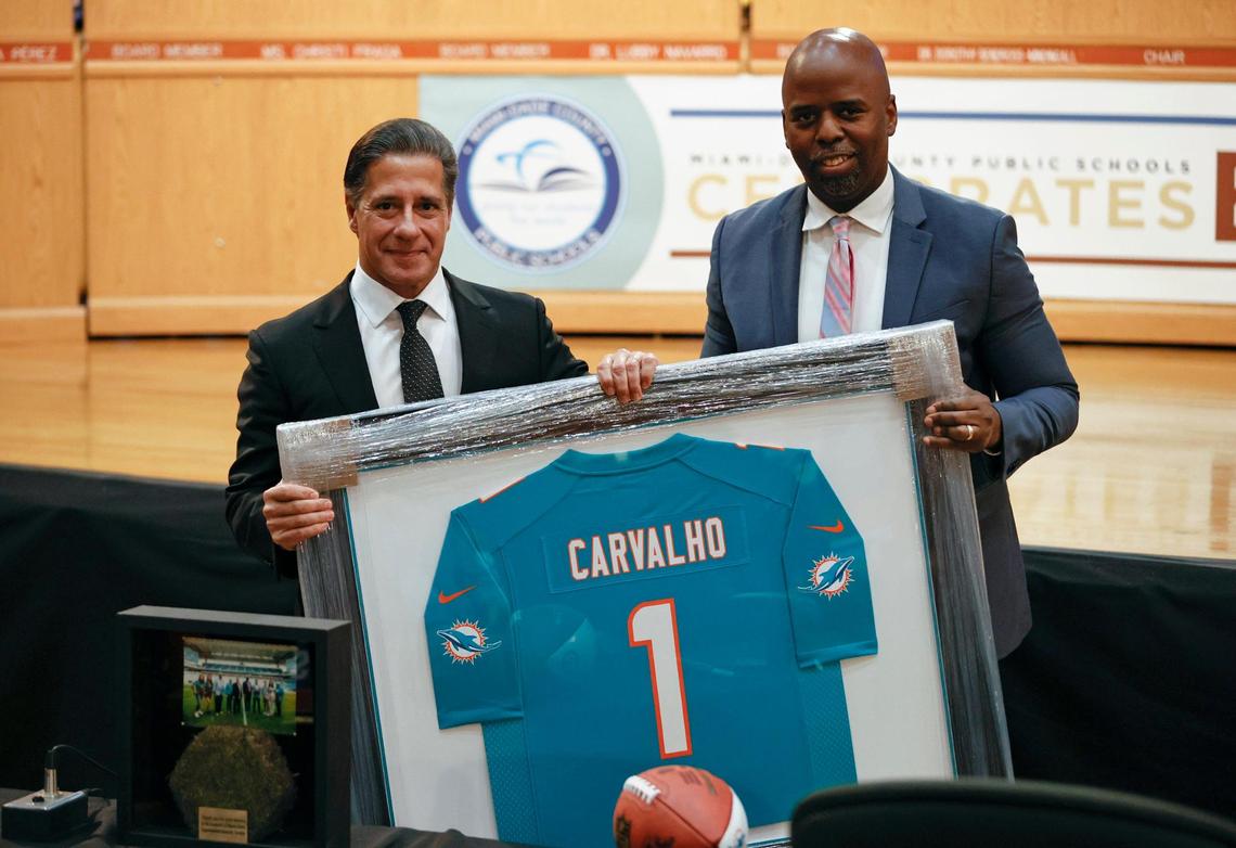 Miami-Dade Public Schools Superintendent Alberto Carvalho gets some gifts from Miami Dolphins Senior Vice President of Communications and Community Affairs Jason Jenkins during his final meeting of the Miami-Dade School Board on Wednesday, Feb. 9, 2022. He is leaving to become superintendent of the Los Angeles school district.
